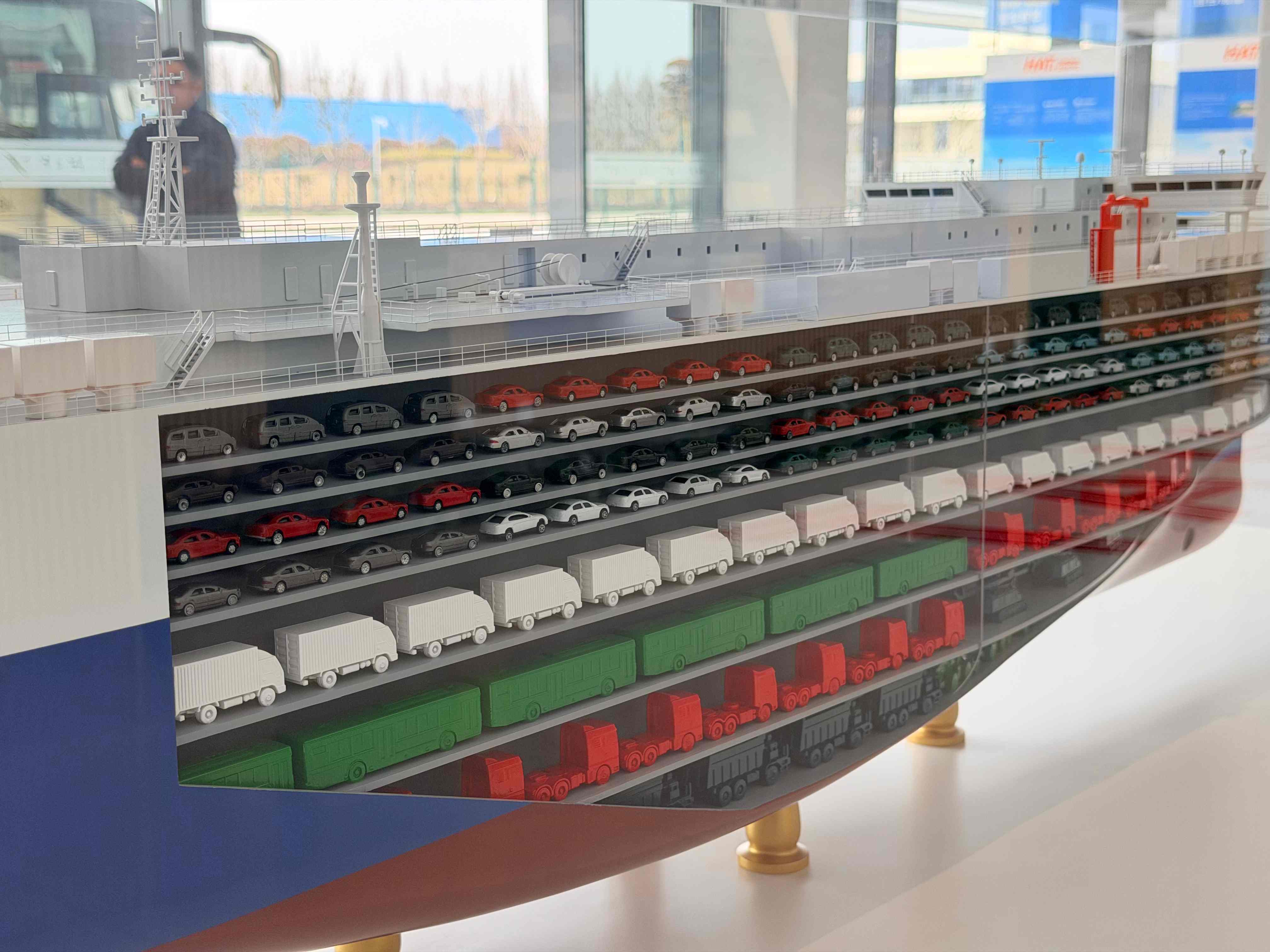 Cutaway model showing the multi-deck interior of a vehicle export logistics RORO vessel